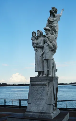 Monument to the Immigrant stands watchfully over the Mississippi River