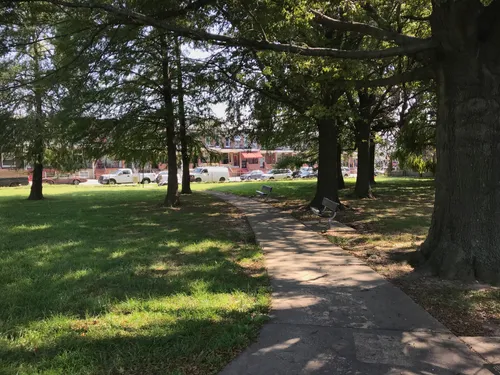 The walking path through the park passes shaded benches