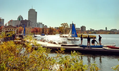 Boats on the Charles River framed by autumn foliage