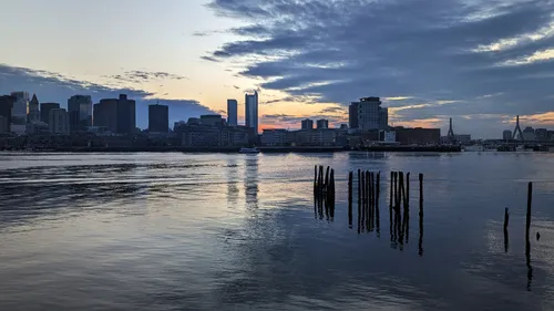 Boston's skyline across the harbor at dusk