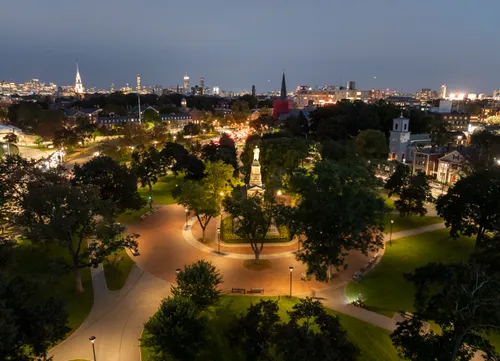 Nighttime view of Cambridge Common with the illuminated Civil War Monument
