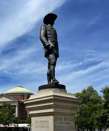 Statue of John Bridge stands in the north corner of the park