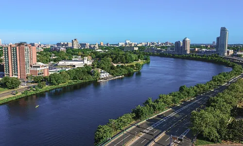 Aerial view of the river curving between Cambridge and Boston neighborhoods