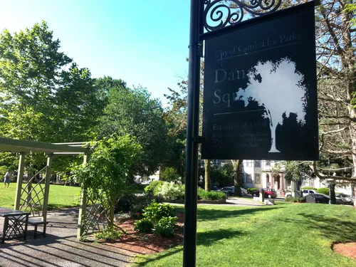 The park sign with a seating area in the background