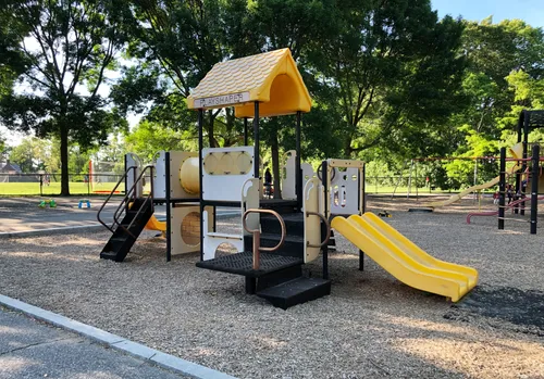 Playground equipment with open fields visible behind