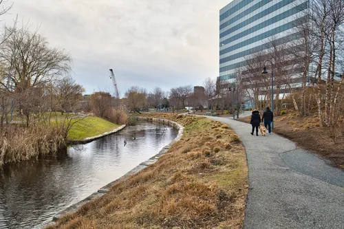 Pedestrian walkway follows the gentle curve of the water
