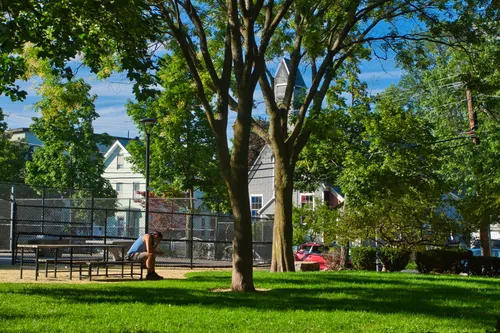 Green space with mature trees and St. Augustine Church visible in the background