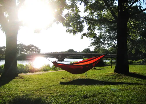 Red hammock strung between trees near John W. Weeks Footbridge