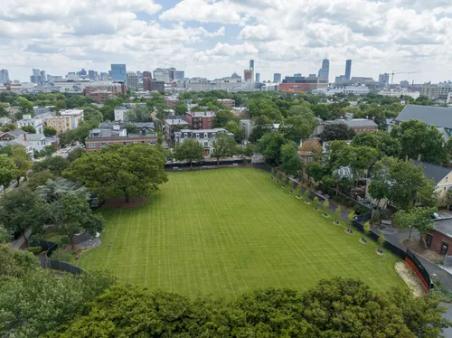Aerial view of the green field with Cambridge's skyline in the background