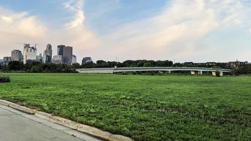 Expansive green space with Minneapolis skyline visible behind