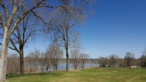 The grassy shore of Lake Hiawatha on a clear spring day
