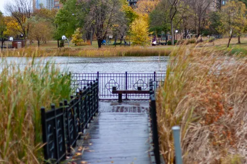 The boardwalk on the south shore of the pond leads toward a platform with two benches