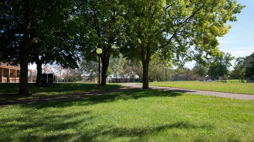 A shaded lawn area in the park's northwest corner