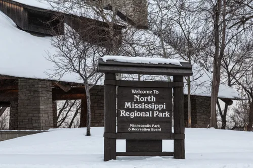 The welcome sign at North Mississippi Regional Park on a snowy winter day