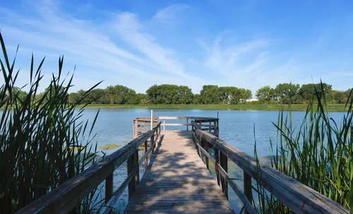 A wooden pier extends into Ryan Lake near Xerxes Avenue