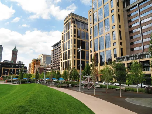 Curving pathway through The Commons with towers rising behind