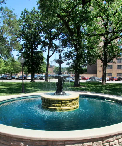 Circular fountain surrounded by trees in downtown Rochester