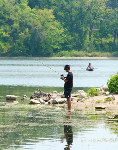 Fishing from the rocky shoreline of Lake Phalen