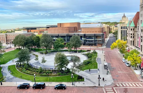View of the plaza with its fountain and surrounding urban buildings