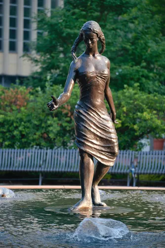 The bronze sculpture The Source stands gracefully in the fountain waters
