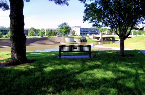 A shaded bench offers a peaceful view across Brush Creek
