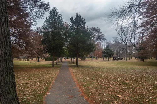 A walking path leads through the late-autumn park landscape
