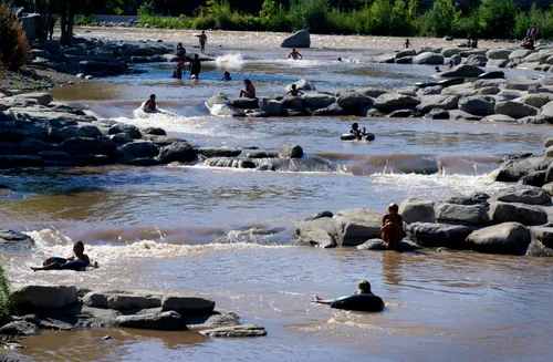 Visitors enjoying the gentle river cascades north of the park