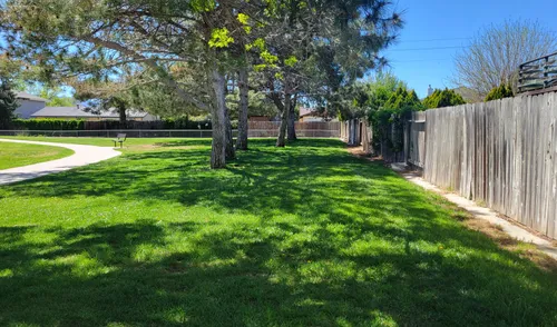 A wooden fence marks the northwest corner of the park
