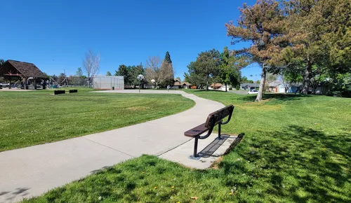 A bench sits along the curving concrete path