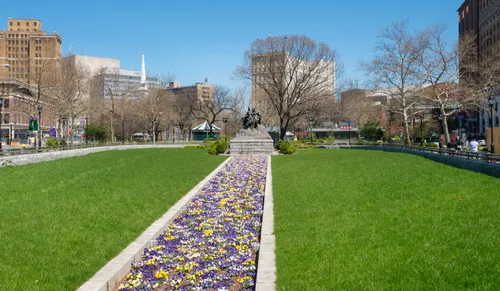 A long colorful flower bed is recessed into the lawn
