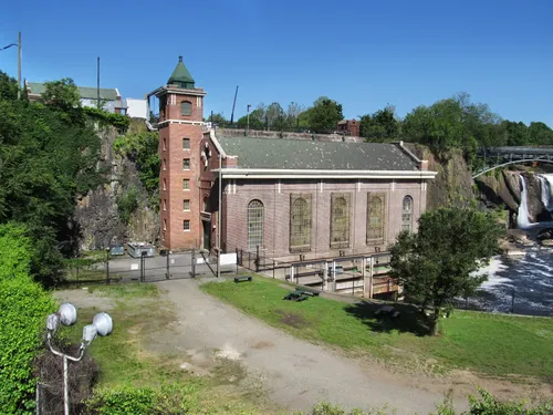 Hydroelectric power plant with tower beside Passaic River waterfall
