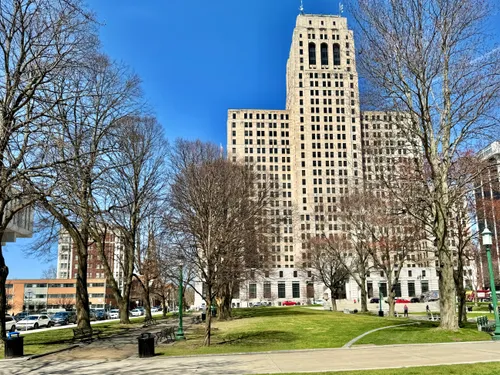 The Alfred E. Smith State Office Building rises beyond the park