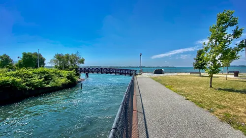 Scenic walking path along the canal with bright blue skies overhead