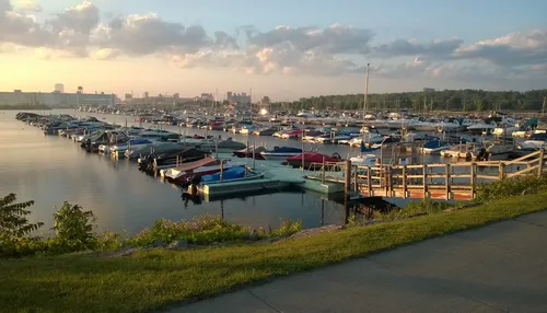 Boats line the docks at Buffalo Harbor as the sun sets over the water