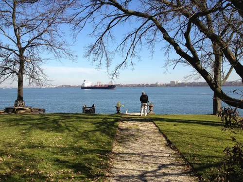 A grassy shoreline path leads visitors to stunning harbor views