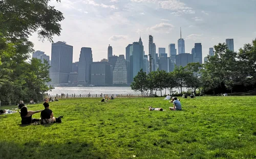 Visitors on the lawn of Pier 1 are enjoying views of Manhattan's skyline