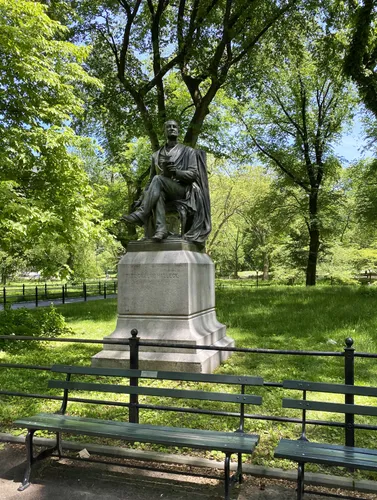 The Fitz-Greene Halleck statue sits surrounded by greenery near the Mall