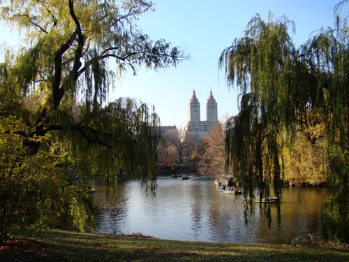 The San Remo's twin towers visible beyond the lake and willows