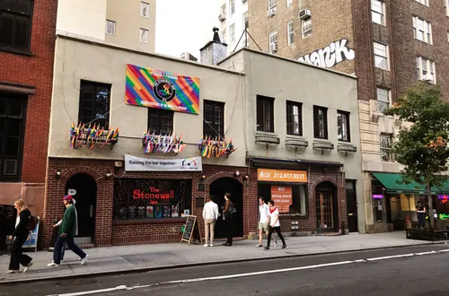 The historic Stonewall Inn on Christopher Street with rainbow flags on display