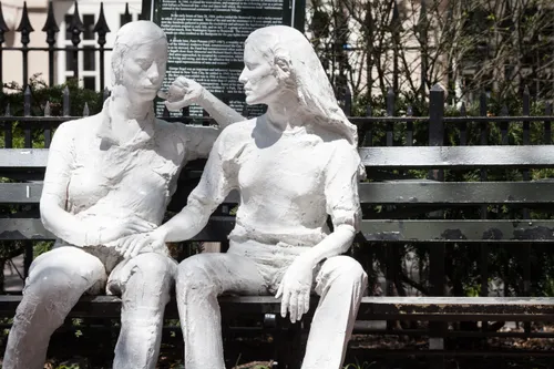 Two seated female figures on their park bench