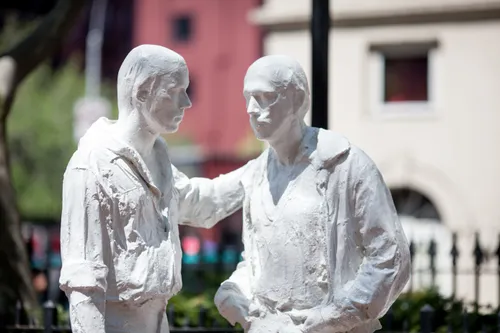 The standing male figures of the Gay Liberation Monument across from the Stonewall Inn