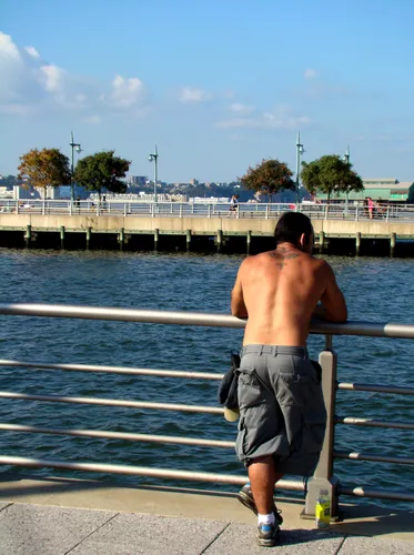 A visitor leans against the railing, with Pier 46 visible beyond