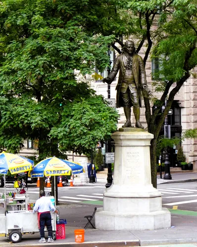 A statue of Benjamin Franklin stands across the street