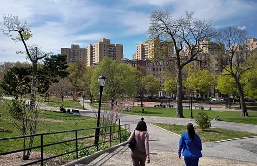 Two visitors enter the park from its southeast corner
