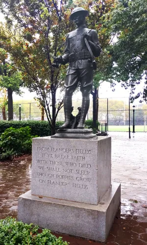 The Clinton War Memorial doughboy holding poppies near the 52nd Street entrance