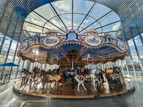 The 48 carved wooden horses of Jane's Carousel inside Jean Nouvel's glass pavilion