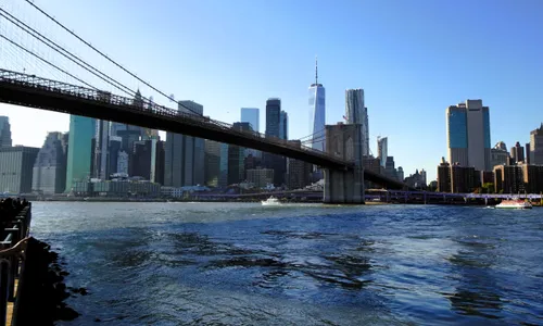 The Brooklyn Bridge spans the East River with Manhattan's skyline in the background