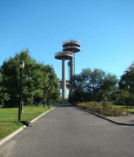 The New York State Pavilion Observation Towers rise against the blue sky