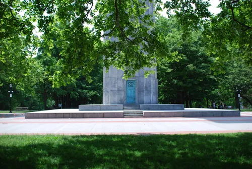 Monument base framed by lush summer greenery