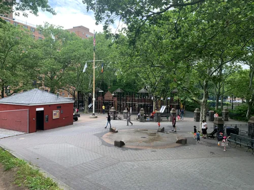 The park's playground area with seating and trees